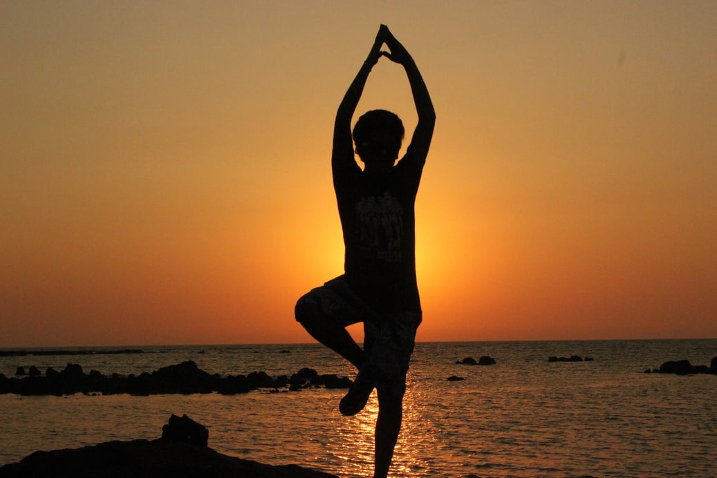 Silhouette of a Person Doing Yoga at the Beach